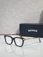 Black eyeglasses with gold metal temples and amber-tinted detail