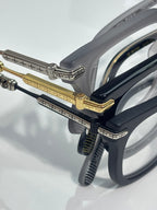 Close-up of gray and gold eyeglass frames with metal hinge details