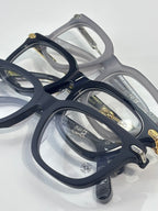 Assorted eyeglasses in navy and gray with gold accents and rectangular lenses
