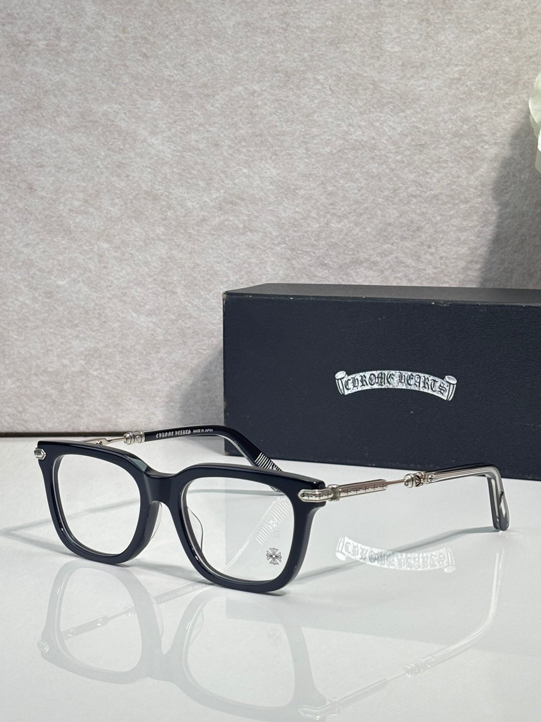 Navy eyeglasses with gold metal temples and rectangular frames
