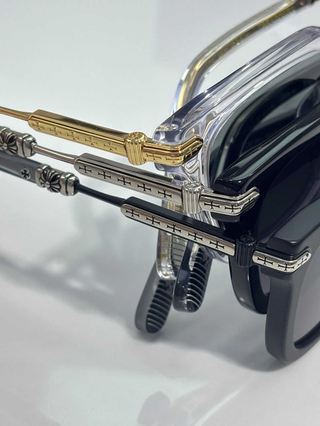 Chrome glasses close-up: gold hinge with clear temples