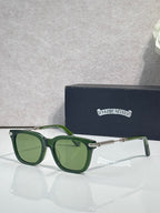 Glasses with green frames, green-tinted lenses, gold-tone metal hinges