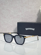 Glasses with dark navy frame, tinted lenses, gold-tone arms