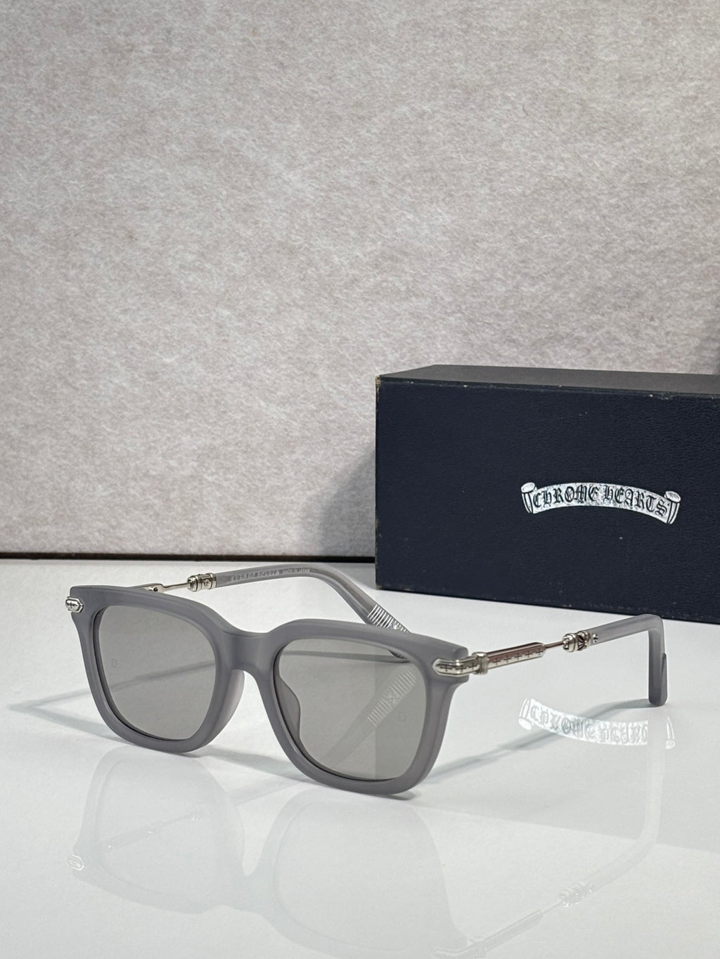 Glasses with gray frame, light gray lenses, silver-tone metal arms