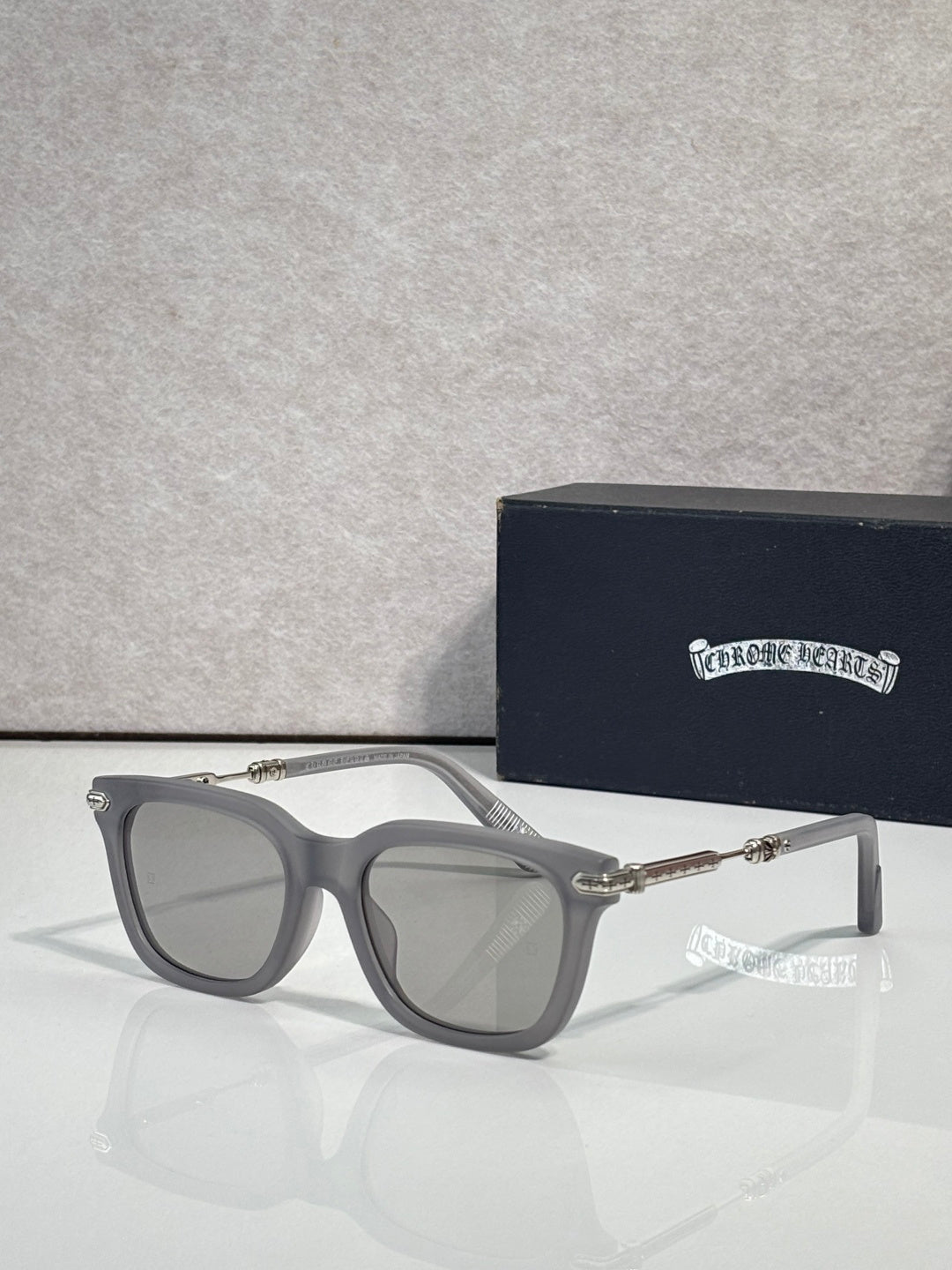 Glasses with gray frame, light gray lenses, silver-tone metal arms