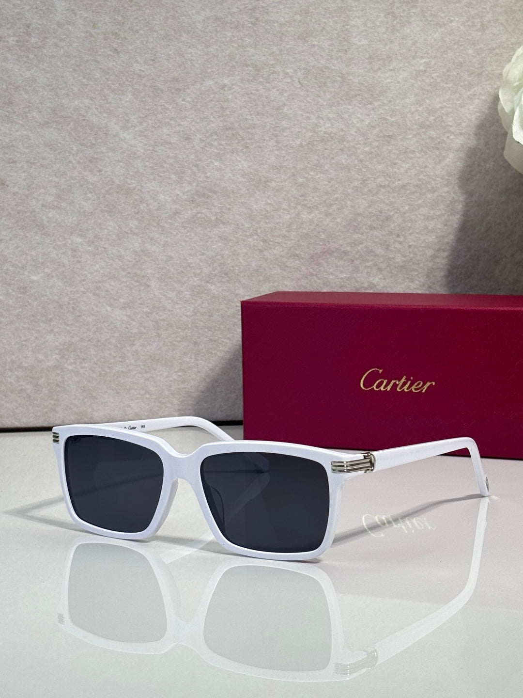 White square sunglasses with dark lenses and gold-tone bridge detail