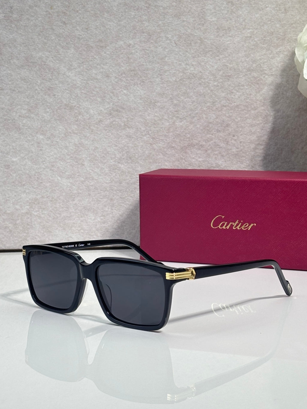 Dark tortoiseshell square sunglasses with dark lenses and gold-tone front detail