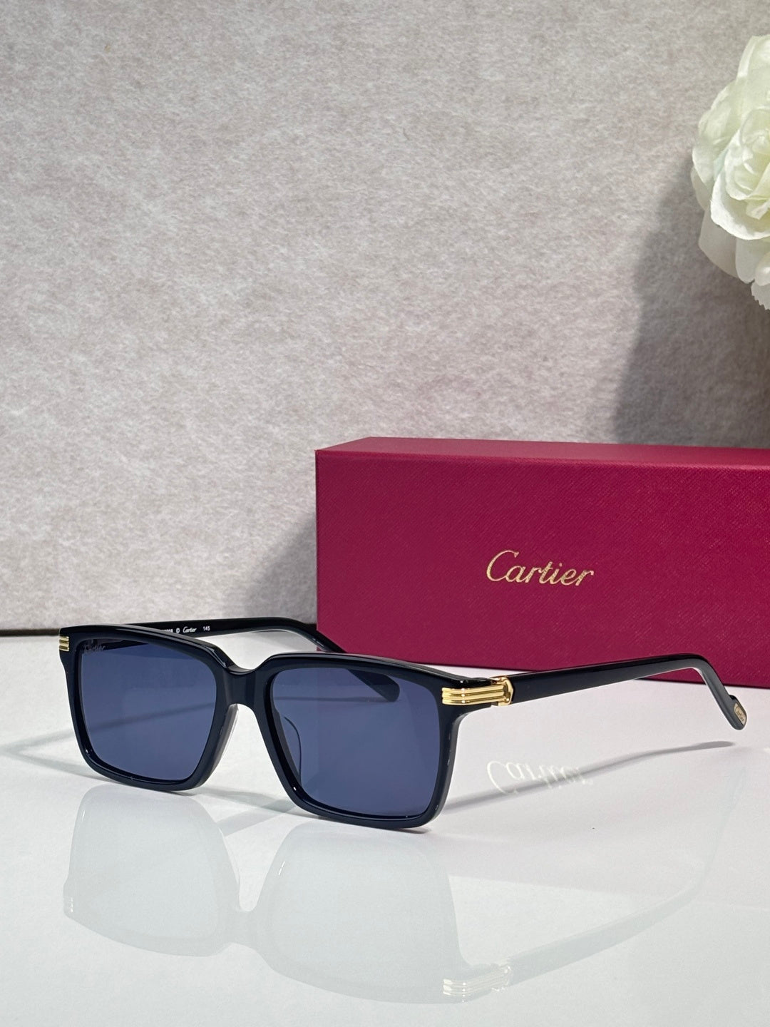Navy square sunglasses with dark lenses and gold-tone bridge detail