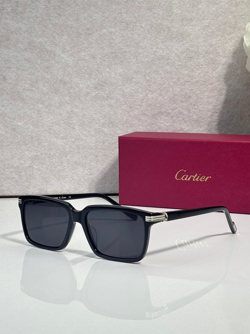 Black square sunglasses with dark lenses and gold-tone accents on the frame