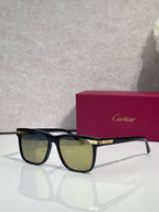 Sunglasses with dark frames and olive-tinted lenses, gold logo plaque