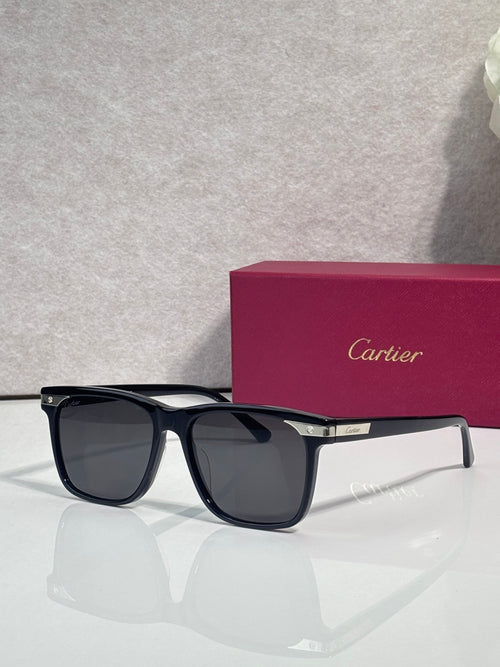 Sunglasses with dark frames and mirrored dark lenses, gold accent at temple
