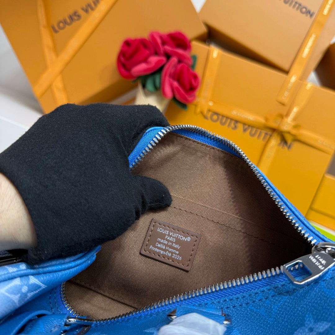 Blue monogram handbag interior lining with zipper close-up and leather label.