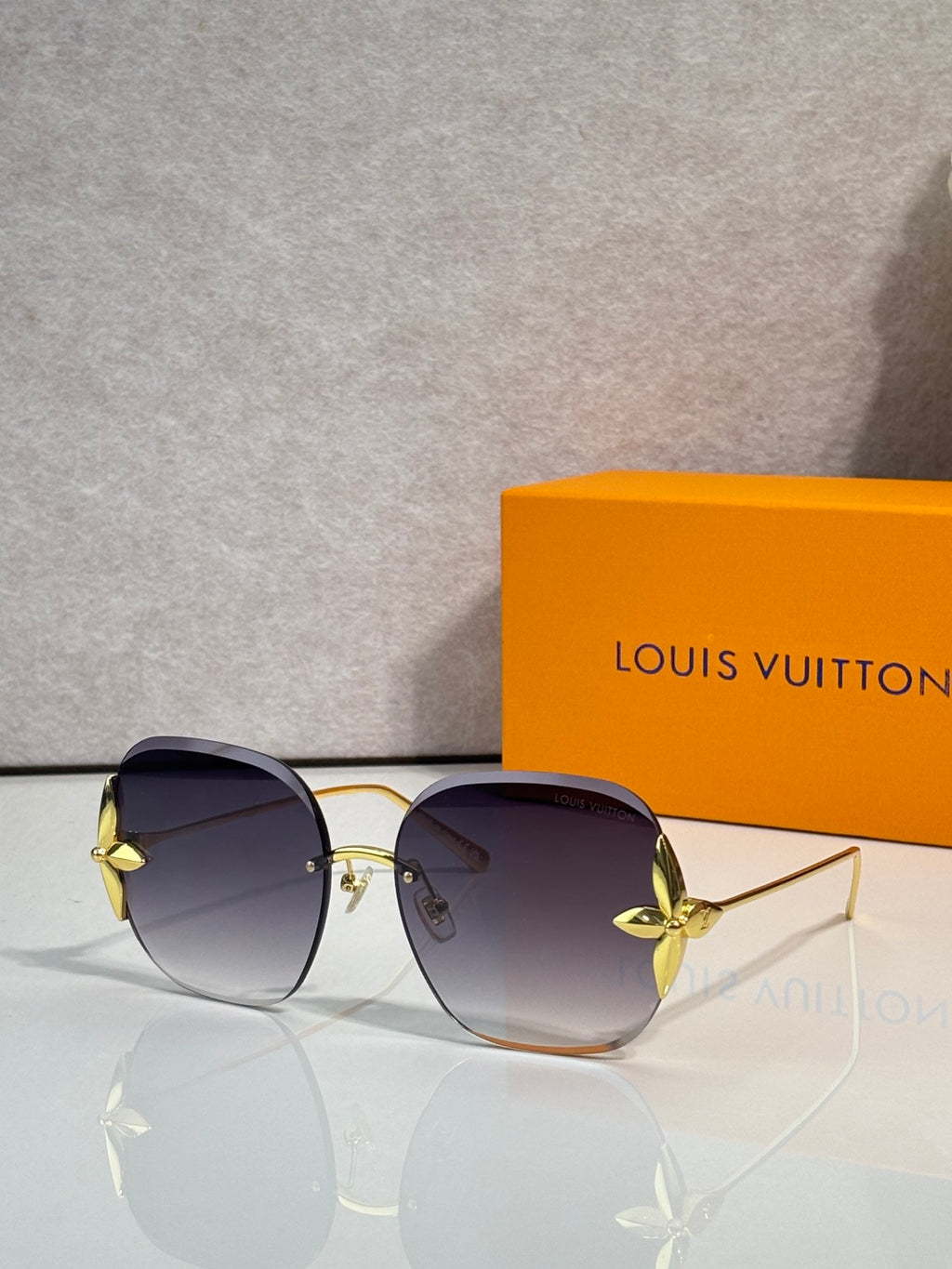 Louis Vuitton glasses with round dark violet-tinted lenses, gold frame and metal bridge