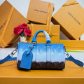 Blue monogram satchel handbag with top handles and shoulder strap, front view.
