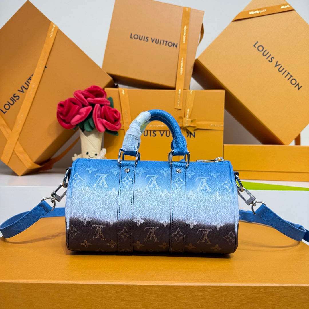 Blue monogram satchel handbag with top handles and side straps, front view.