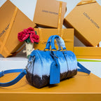 Blue monogram handbag with short handles and shoulder strap, front three-quarter view.