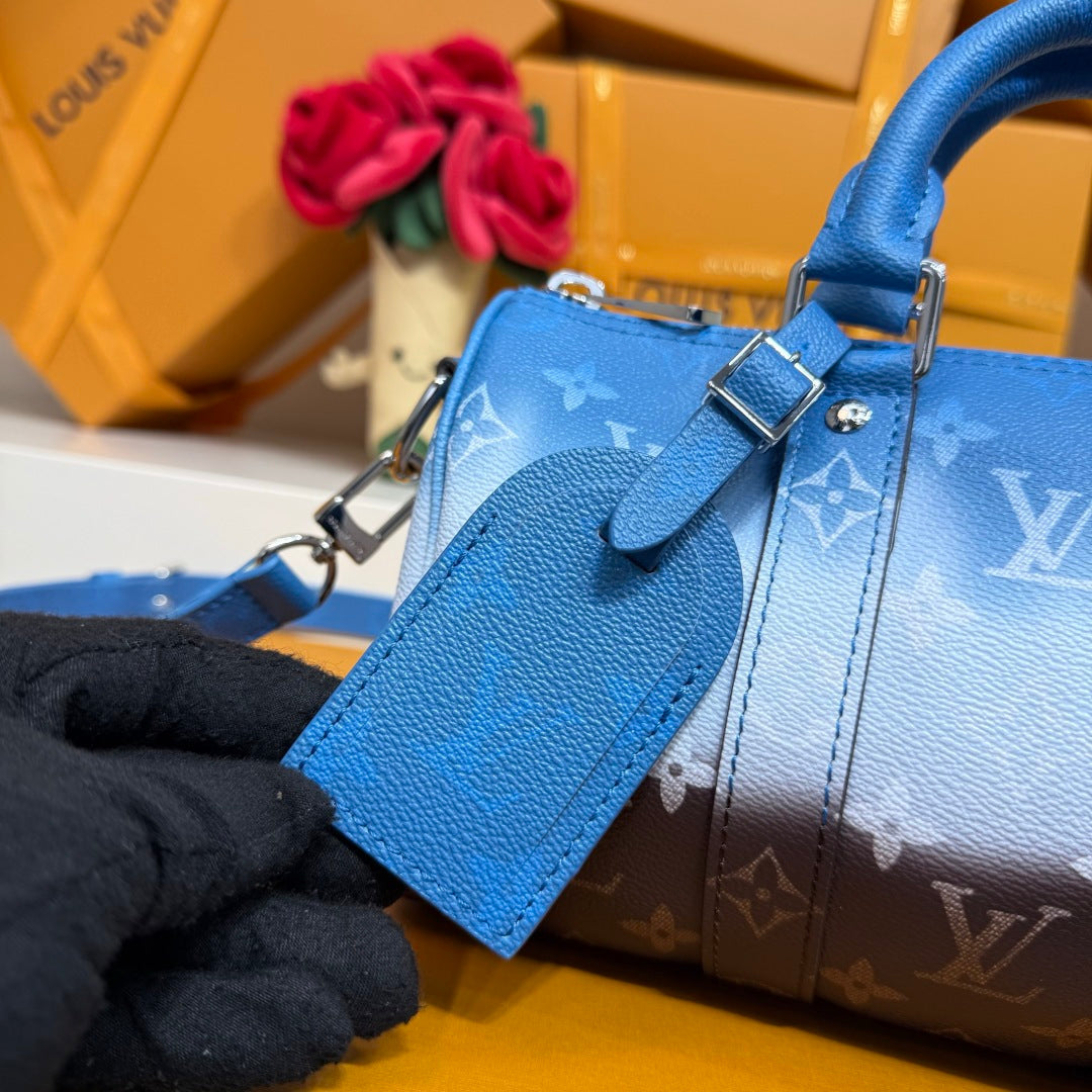 Blue monogram handbag detail with front strap, buckle hardware, and smooth leather panel.