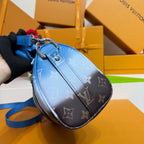 Blue monogram mini handbag with metal clasp and detachable strap, side view.