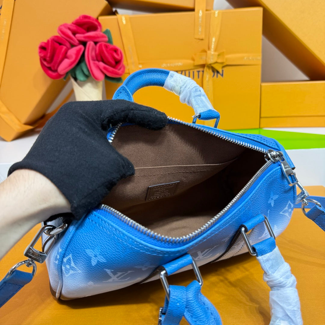 Blue monogram mini handbag open top with interior view and adjustable strap.