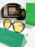 Bottega Veneta sunglasses with dark tortoise frame and yellow mirrored lenses, gold arms.