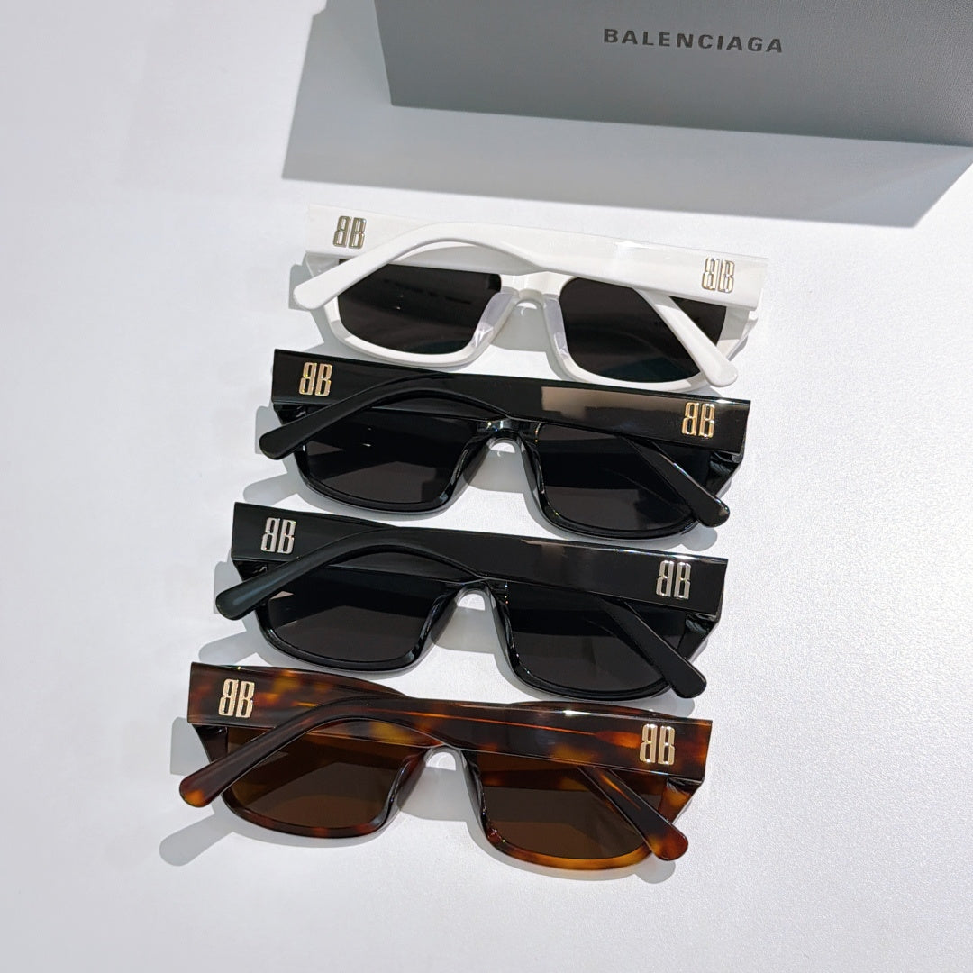 Assorted Balenciaga sunglasses stack: white, black, and brown frames with dark lenses