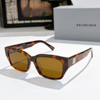 Balenciaga sunglasses with tortoiseshell frames and amber tinted lenses, cat-eye shape