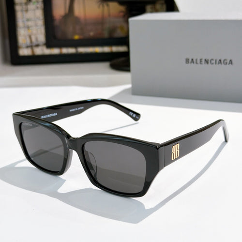 Balenciaga sunglasses with black frames and dark tinted lenses, cat-eye shape
