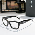Prada eyeglasses with black full-rim frame and clear lenses, angled front view