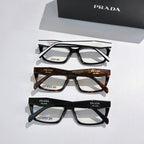 Three pairs of Prada eyeglasses with black and tortoiseshell full-rim frames and clear lenses
