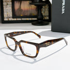 Prada eyeglasses with dark tortoiseshell full-rim frame and clear lenses, side angle