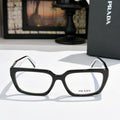 Prada eyeglasses with black full-rim frame and clear lenses, rectangular rounded shape
