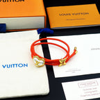 Louis Vuitton red cord bracelet with gold heart charm and bow accent