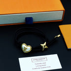 Black cord bracelet with gold heart charm and gold star accent