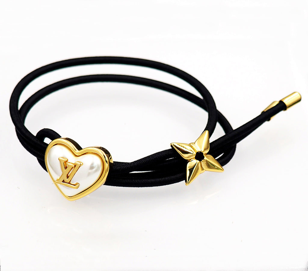 Black cord bracelet with gold heart charm and gold star accent