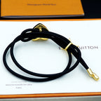 Black cord bracelet with gold heart and gold star charms