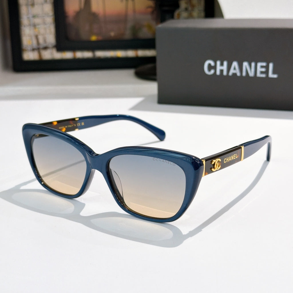 Blue cat-eye sunglasses with light lenses and gold Chanel logo on temple