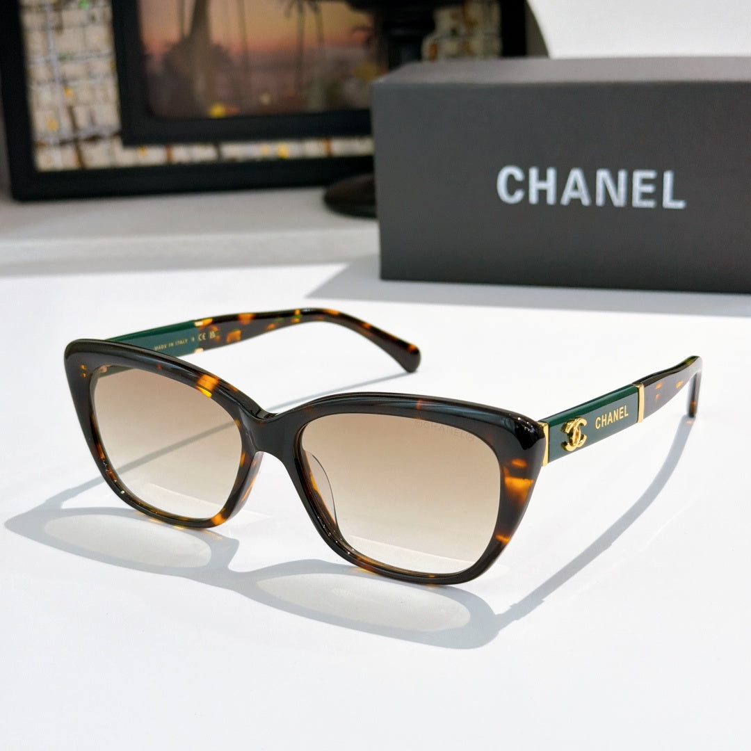Tortoiseshell cat-eye sunglasses with light-tinted lenses and gold temple logo