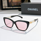 Black cat-eye sunglasses with pink-tinted lenses and gold Chanel logo on temple