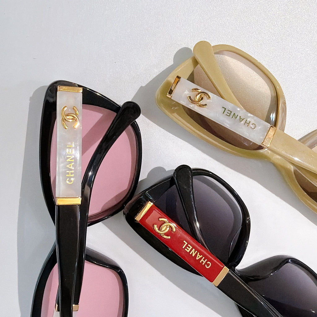 Two cat-eye sunglasses side view: black with pink lenses and tan with tinted lenses