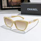 Cream cat-eye sunglasses with light-tinted lenses and gold Chanel logo on temple