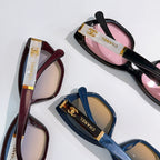 Chanel sunglasses close-up, maroon and black/pink frames, plus blue pair