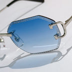 Cartier sunglasses close-up with blue tinted lens and metal gold frame details