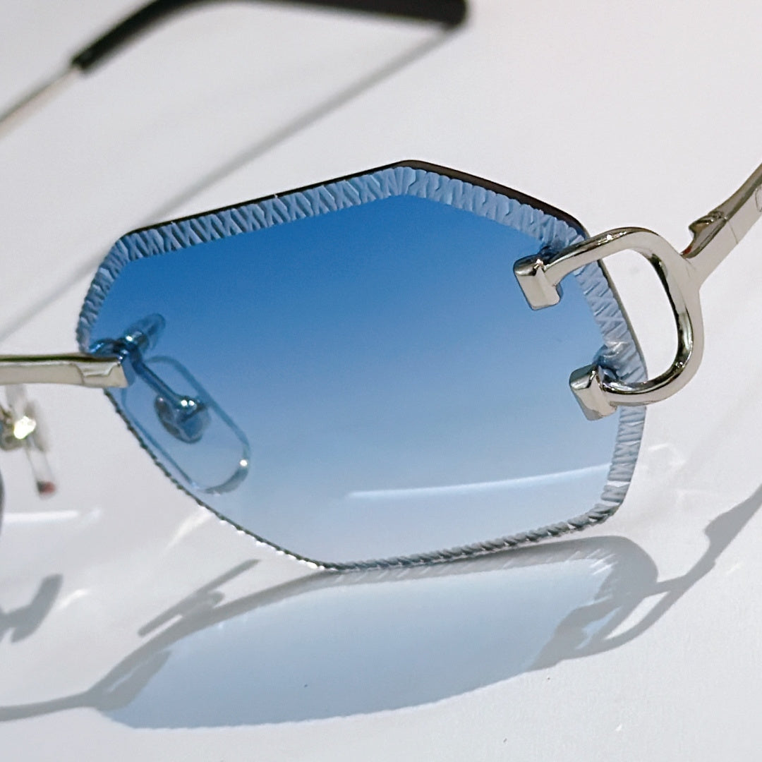 Cartier sunglasses close-up with blue tinted lens and metal gold frame details