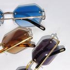 Stacked Cartier sunglasses with blue, brown, and purple tinted lenses, gold frames