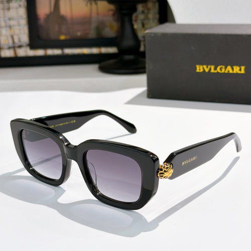 Black cat-eye sunglasses with dark lenses and gold logo accent on the bridge.