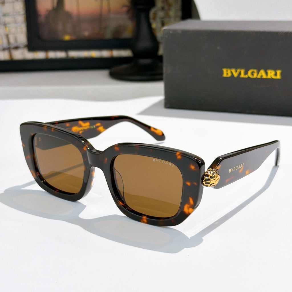 Tortoise cat-eye sunglasses with amber-brown lenses and gold logo bridge detail.