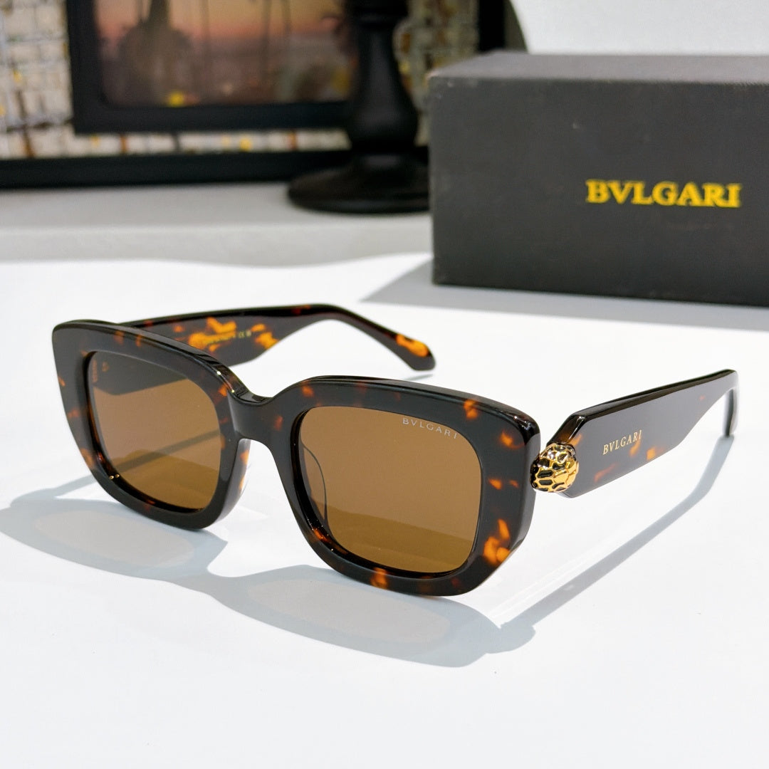 Tortoise cat-eye sunglasses with amber-brown lenses and gold logo bridge detail.