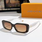 Louis Vuitton sunglasses with black frames, brown lenses, gold-tone tips.