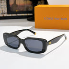 Louis Vuitton sunglasses with dark frames, blue lenses, gold-tone tips.