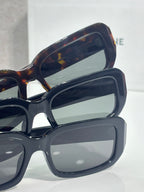 Celine sunglasses close-up showing layered dark frames and tinted lenses